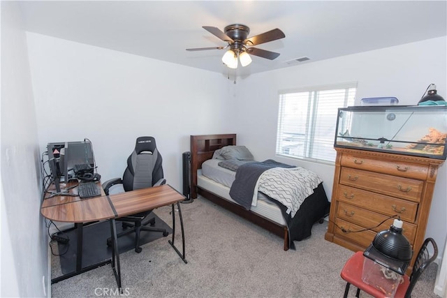 bedroom with light carpet, ceiling fan, and visible vents