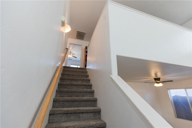 stairway with a ceiling fan and visible vents