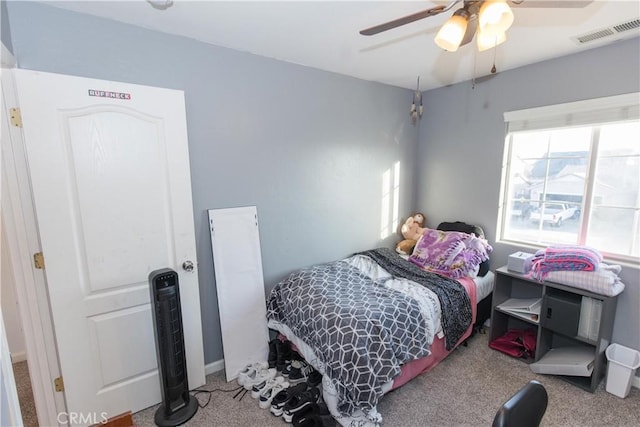 bedroom with ceiling fan, visible vents, and carpet flooring