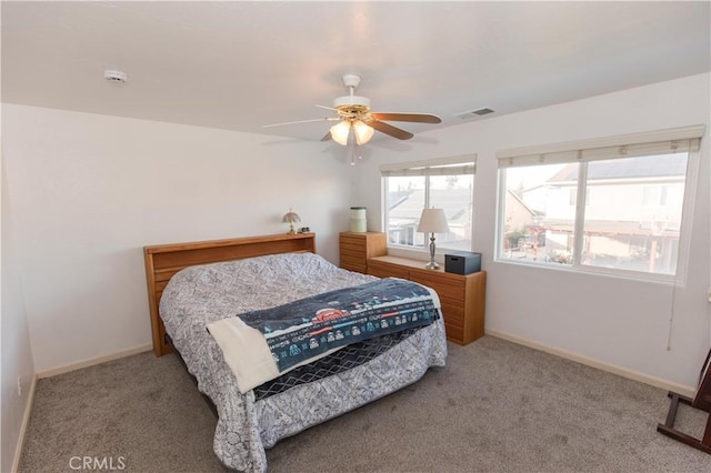 bedroom featuring visible vents, ceiling fan, light carpet, and baseboards