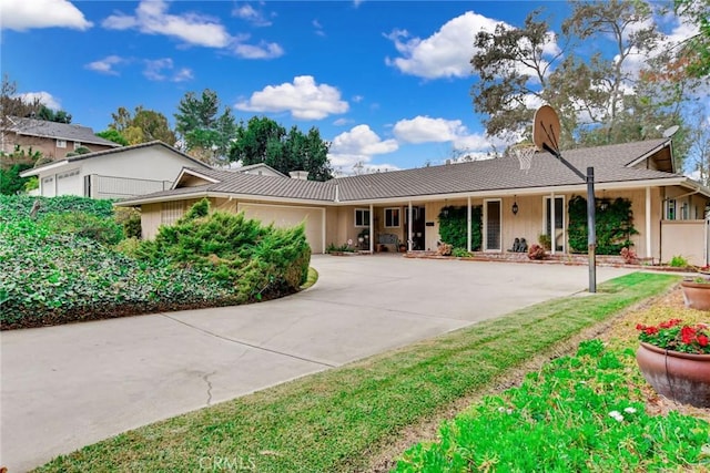 ranch-style house with a garage and driveway