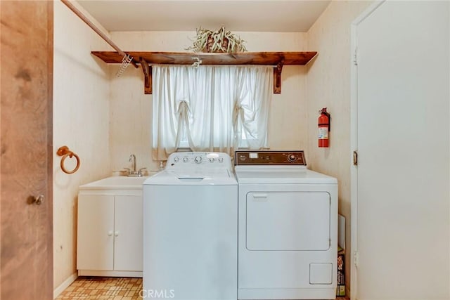 laundry area with cabinet space, washer and clothes dryer, and light floors