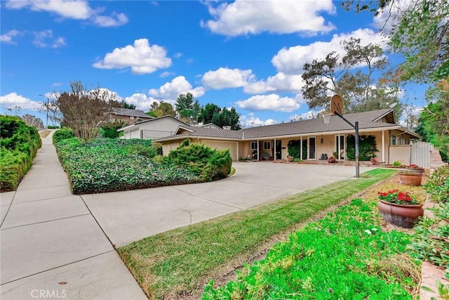 single story home with an attached garage, driveway, and stucco siding