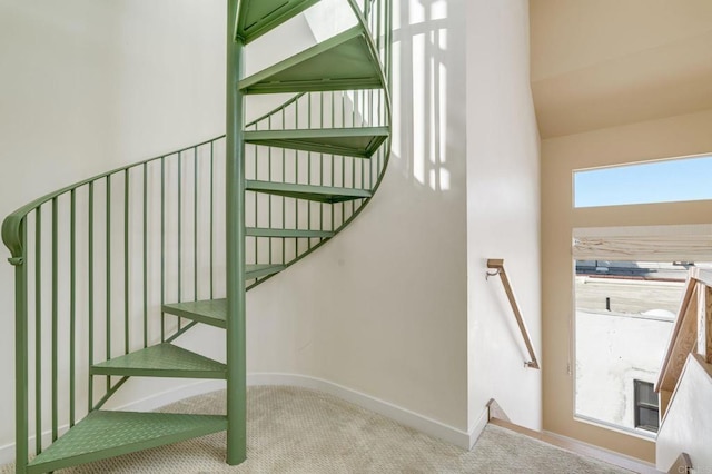 staircase featuring carpet flooring and baseboards