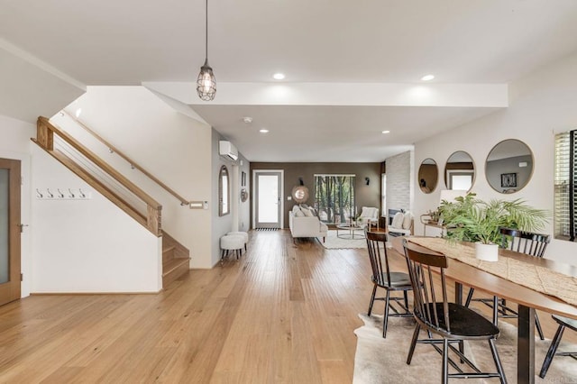 foyer with light wood-style floors, recessed lighting, stairway, and a wall mounted AC