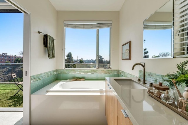 full bathroom featuring a bath and vanity