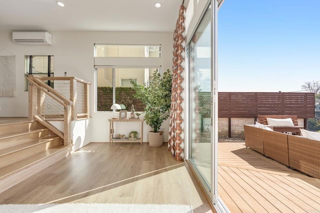 entryway featuring recessed lighting, an AC wall unit, and wood finished floors