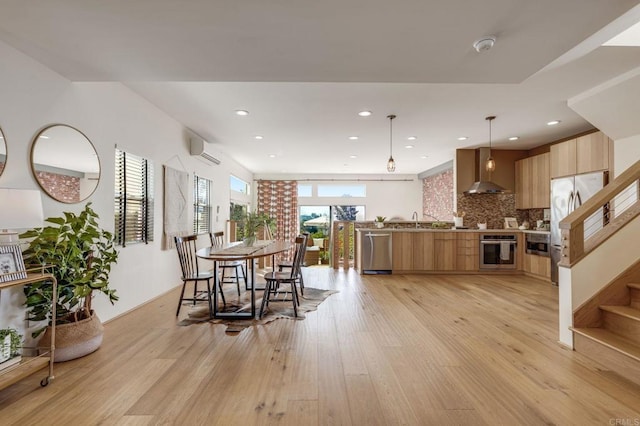 dining room with light wood finished floors, recessed lighting, stairway, and a wall mounted AC