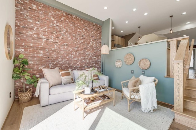 interior space featuring brick wall, baseboards, wood finished floors, and recessed lighting