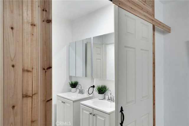 full bath featuring two vanities and a sink