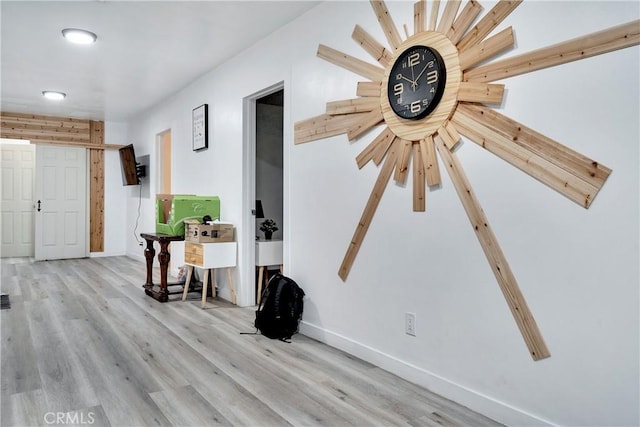 interior space featuring wood finished floors and baseboards