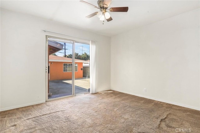 carpeted empty room featuring a ceiling fan and baseboards