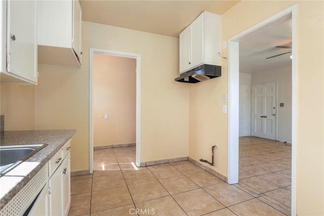 kitchen featuring under cabinet range hood, light tile patterned floors, white cabinetry, and a ceiling fan