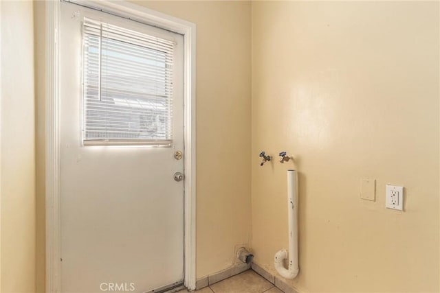 clothes washing area featuring laundry area, light tile patterned floors, and hookup for a washing machine