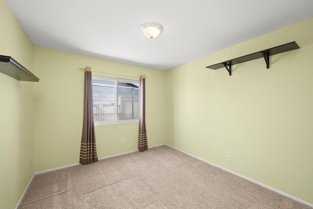 empty room with carpet flooring and baseboards