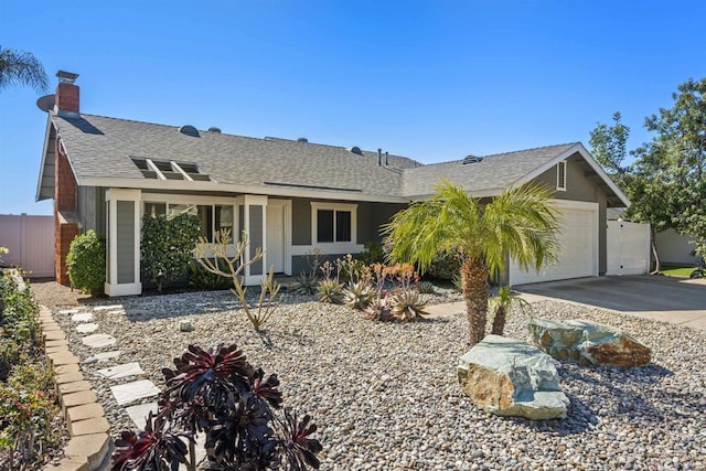 ranch-style house featuring a garage, driveway, fence, and roof with shingles