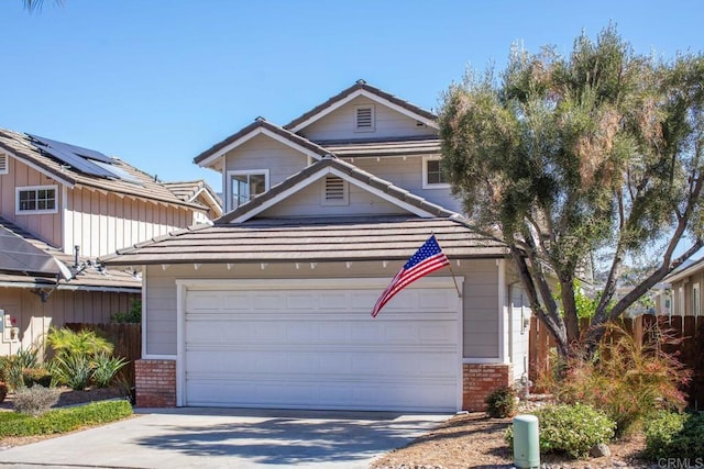 traditional-style home featuring a tile roof, concrete driveway, and brick siding