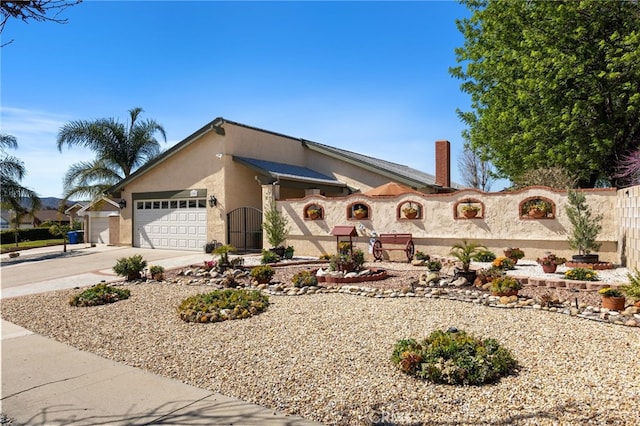 view of front of home with an attached garage, concrete driveway, and stucco siding