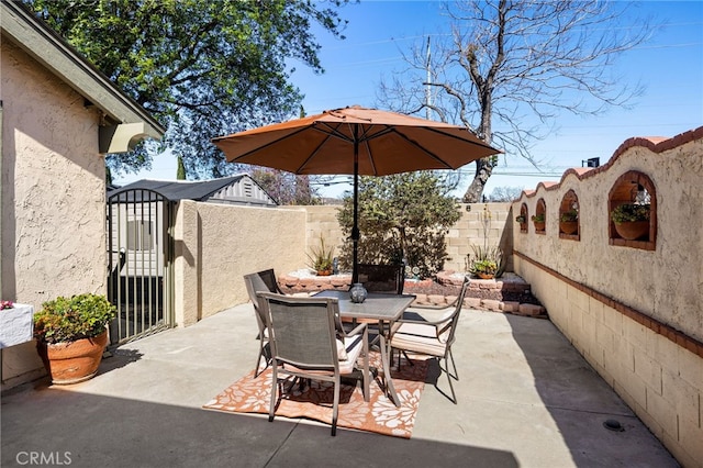 view of patio featuring outdoor dining area and a fenced backyard