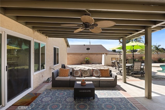 view of patio / terrace featuring ceiling fan, fence, an outdoor hangout area, and outdoor dining space