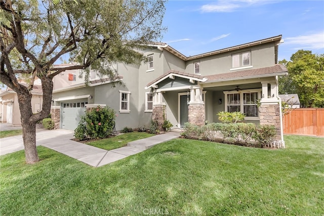 view of front of home with stone siding, fence, stucco siding, and a front yard