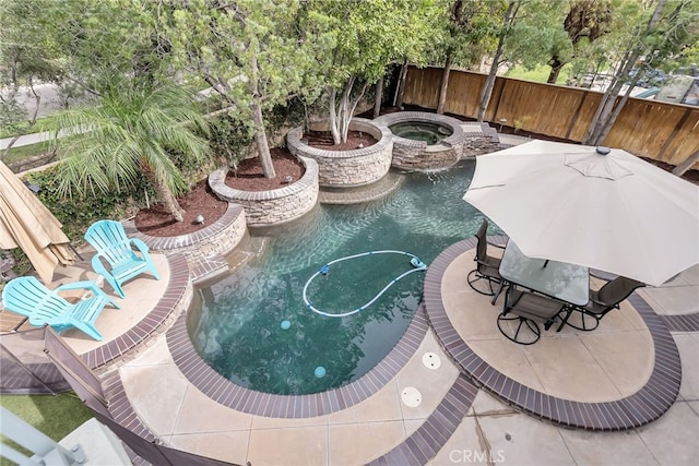 view of swimming pool featuring a fenced in pool, a patio area, fence, and an in ground hot tub