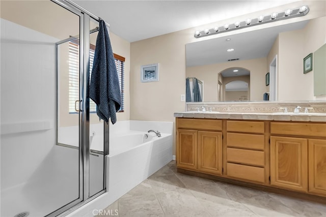 bathroom with a sink, visible vents, a bath, double vanity, and a stall shower