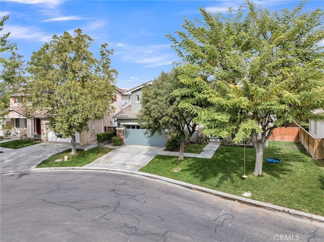 view of property hidden behind natural elements featuring driveway, an attached garage, fence, a front lawn, and stucco siding