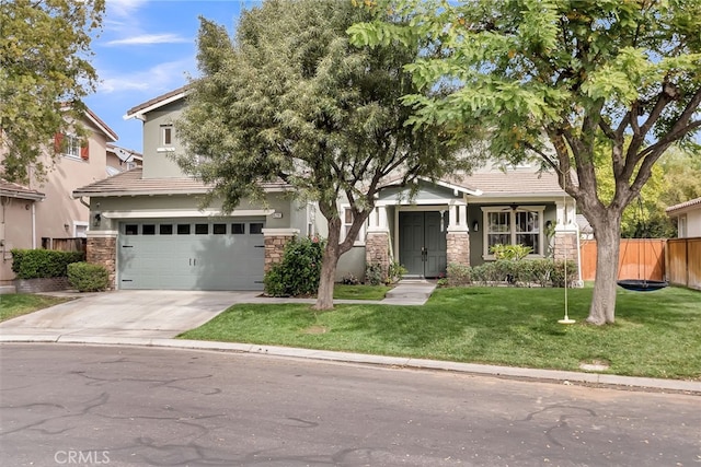 view of front of home featuring stone siding, fence, a front lawn, and concrete driveway