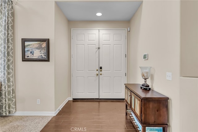 entrance foyer featuring baseboards and wood tiled floor