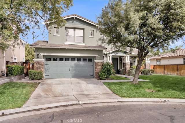 craftsman-style house featuring concrete driveway, stone siding, fence, a front lawn, and stucco siding