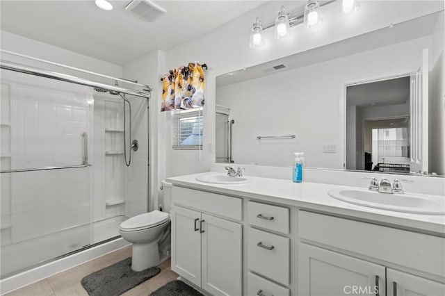 full bath featuring visible vents, a sink, and a shower stall