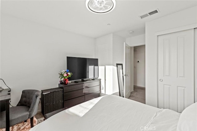 carpeted bedroom featuring visible vents