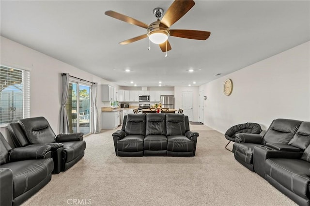 living room featuring recessed lighting, light carpet, and ceiling fan