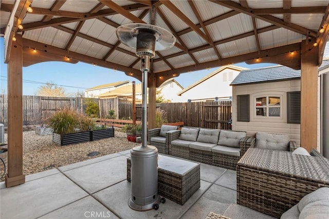 view of patio / terrace with a fenced backyard, an outdoor living space, and a gazebo