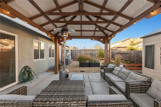 view of patio with a fenced backyard, outdoor lounge area, and a gazebo