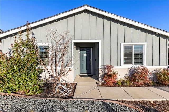 view of exterior entry featuring board and batten siding