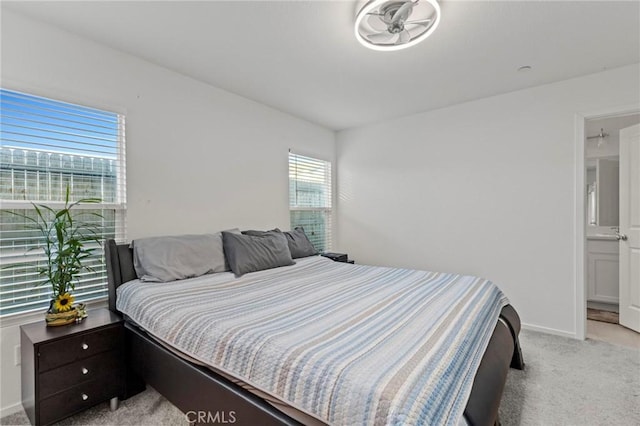 bedroom featuring baseboards and light colored carpet