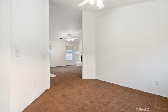 carpeted spare room featuring ceiling fan