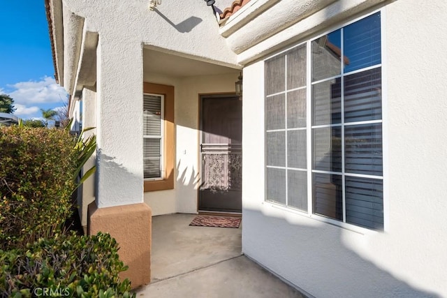 doorway to property with stucco siding