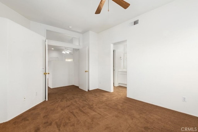 unfurnished bedroom featuring ensuite bath, carpet, visible vents, and ceiling fan