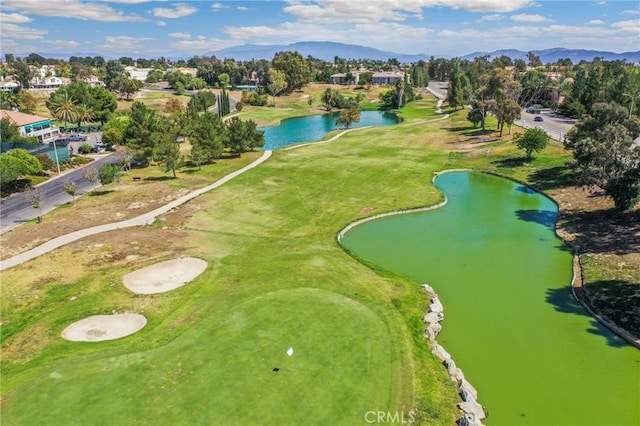 bird's eye view with view of golf course and a water and mountain view