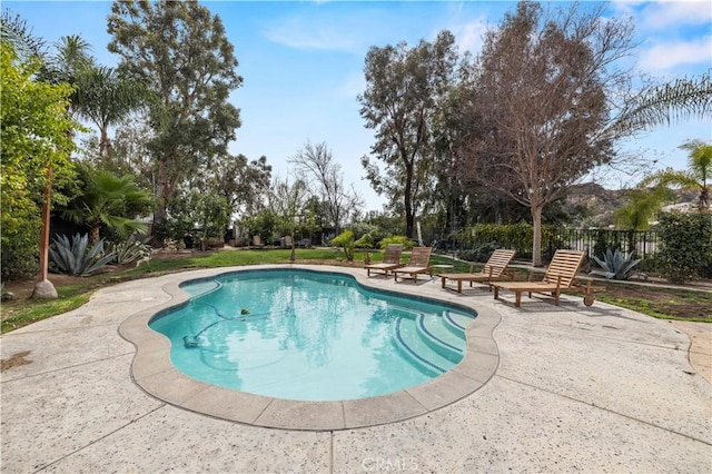 view of swimming pool with a patio, fence, and a fenced in pool