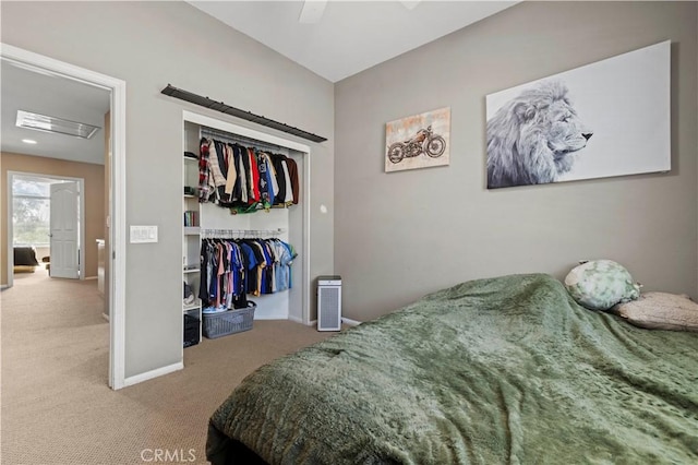 carpeted bedroom with a ceiling fan, a closet, and baseboards