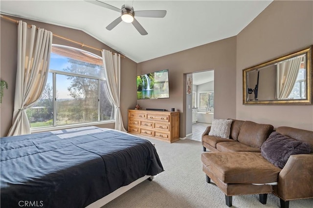 bedroom with vaulted ceiling, carpet, a ceiling fan, and ensuite bathroom