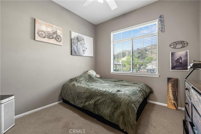 carpeted bedroom featuring ceiling fan and baseboards