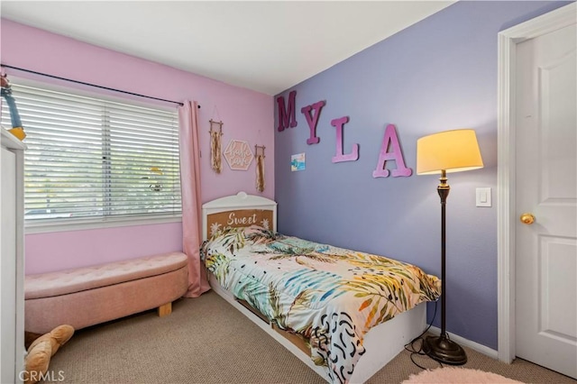 carpeted bedroom featuring baseboards