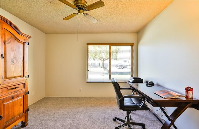 office space featuring carpet floors, ceiling fan, and a textured ceiling