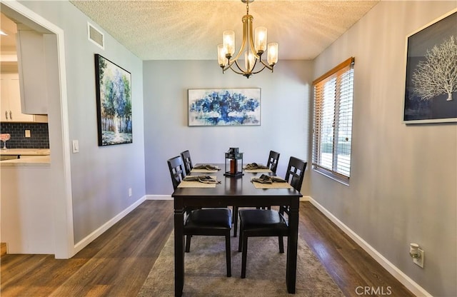 dining area featuring visible vents, a textured ceiling, baseboards, and dark wood-type flooring