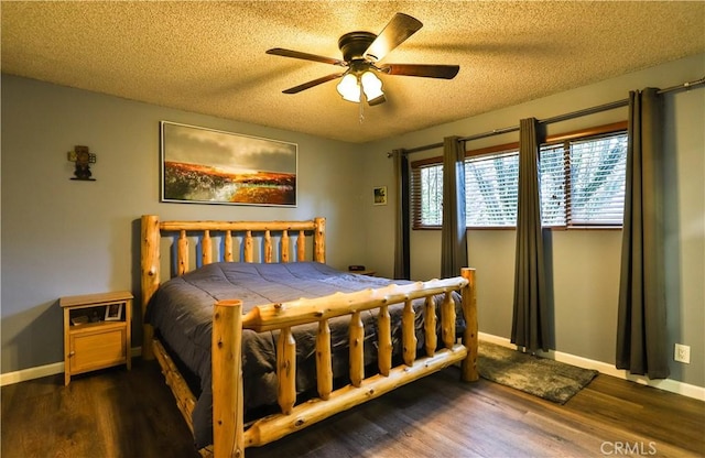 bedroom featuring a ceiling fan, a textured ceiling, baseboards, and wood finished floors